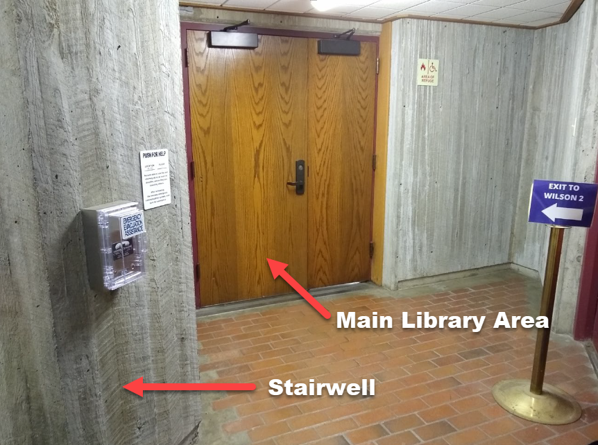 Area of refuge is the space between the wooden doors to the library and the concrete stairwell, where a two-way communication device is located.